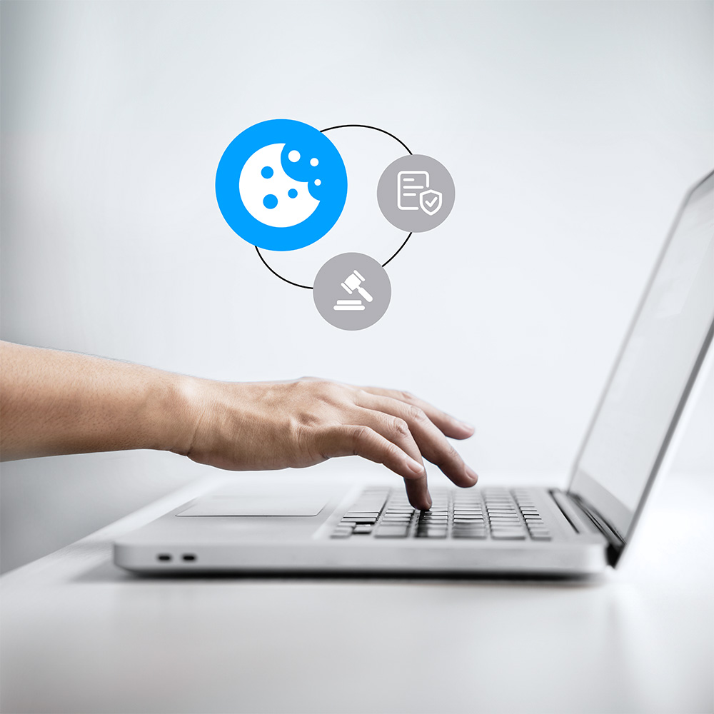 Hand pressing on laptop keyboard with cookies