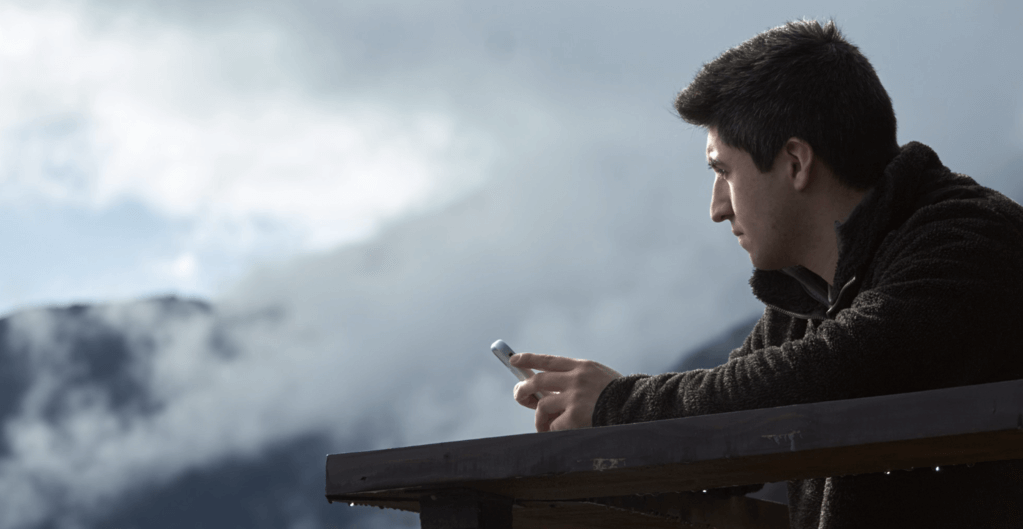 Man with phone looking to the horizon