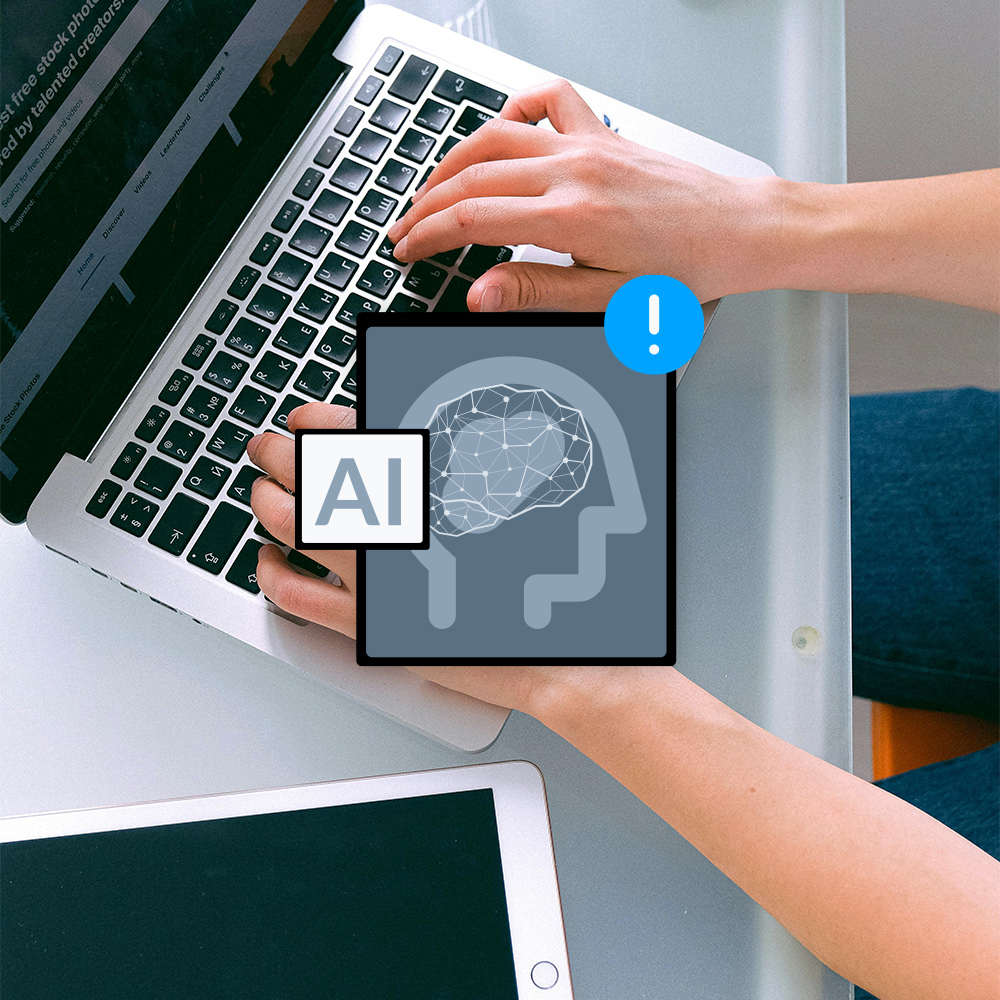 Image of a person typing in a computer and some IA icons